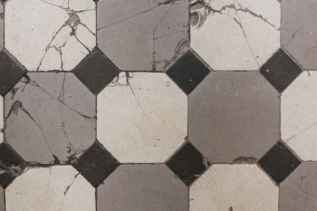 Cracked and broken tiled floor inside a home caused by accidental damage